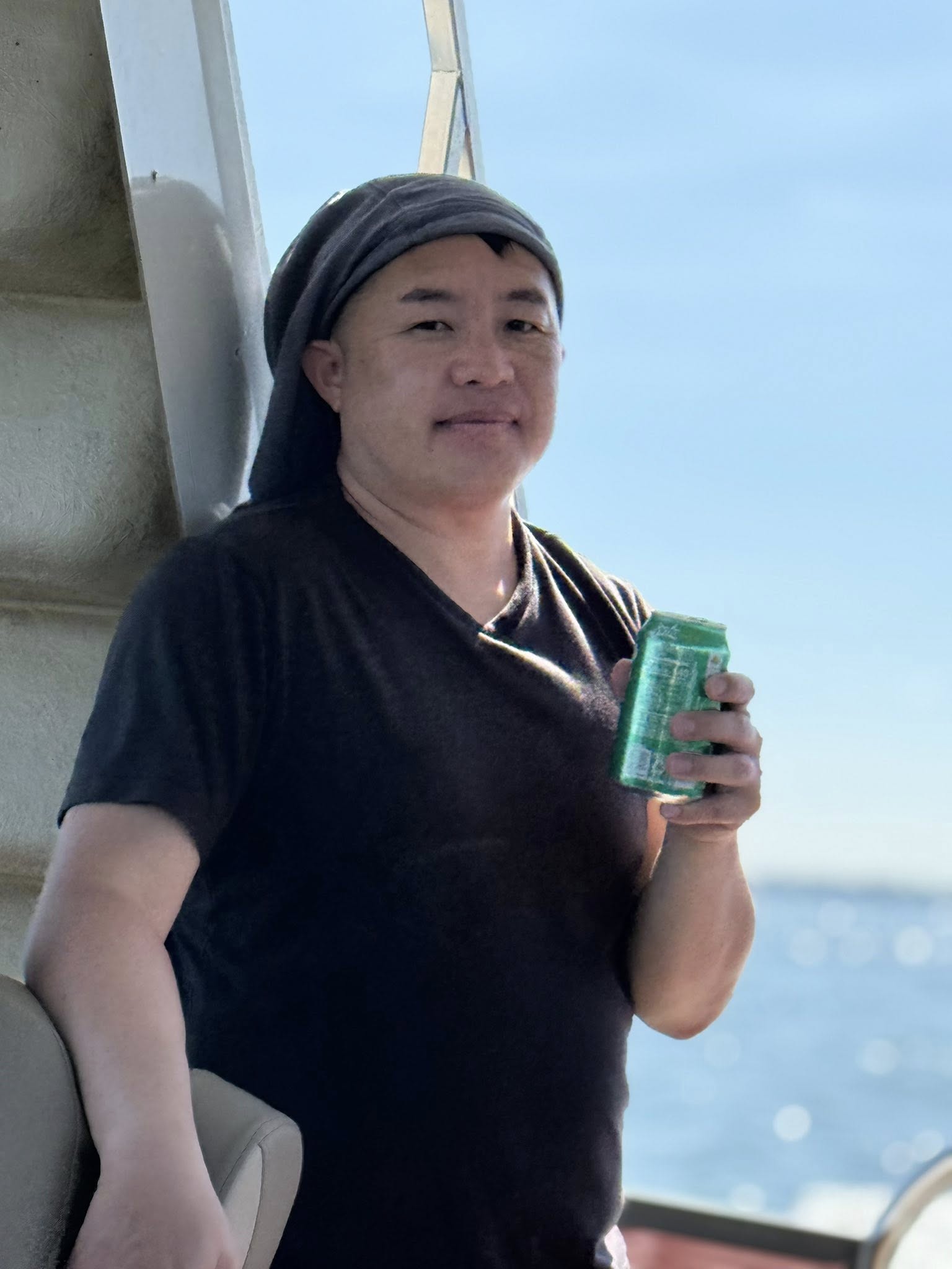 Brother seated on the boat smiling